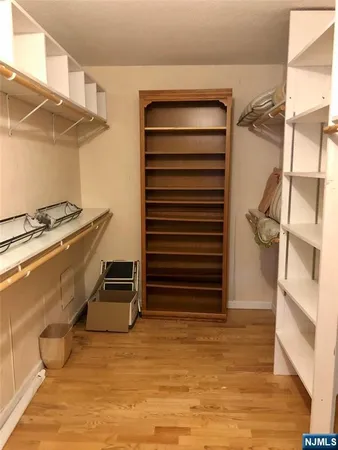 a bathroom with a granite countertop sink and a toilet