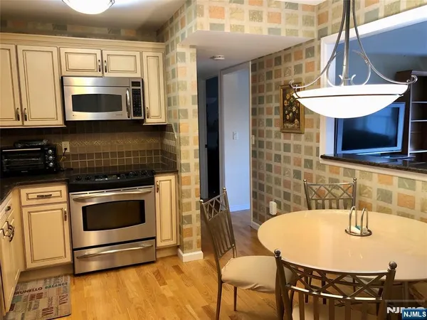 a kitchen with stainless steel appliances a stove a microwave and a sink