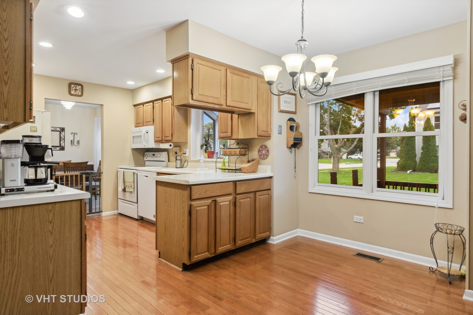 2120 Savannah Road Elgin, IL 60123 - Photo 8 of 26 a kitchen with kitchen island granite countertop a stove a sink a refrigerator cabinets and wooden floor