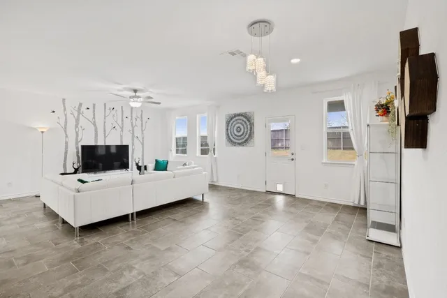 a living room with furniture and a flat screen tv