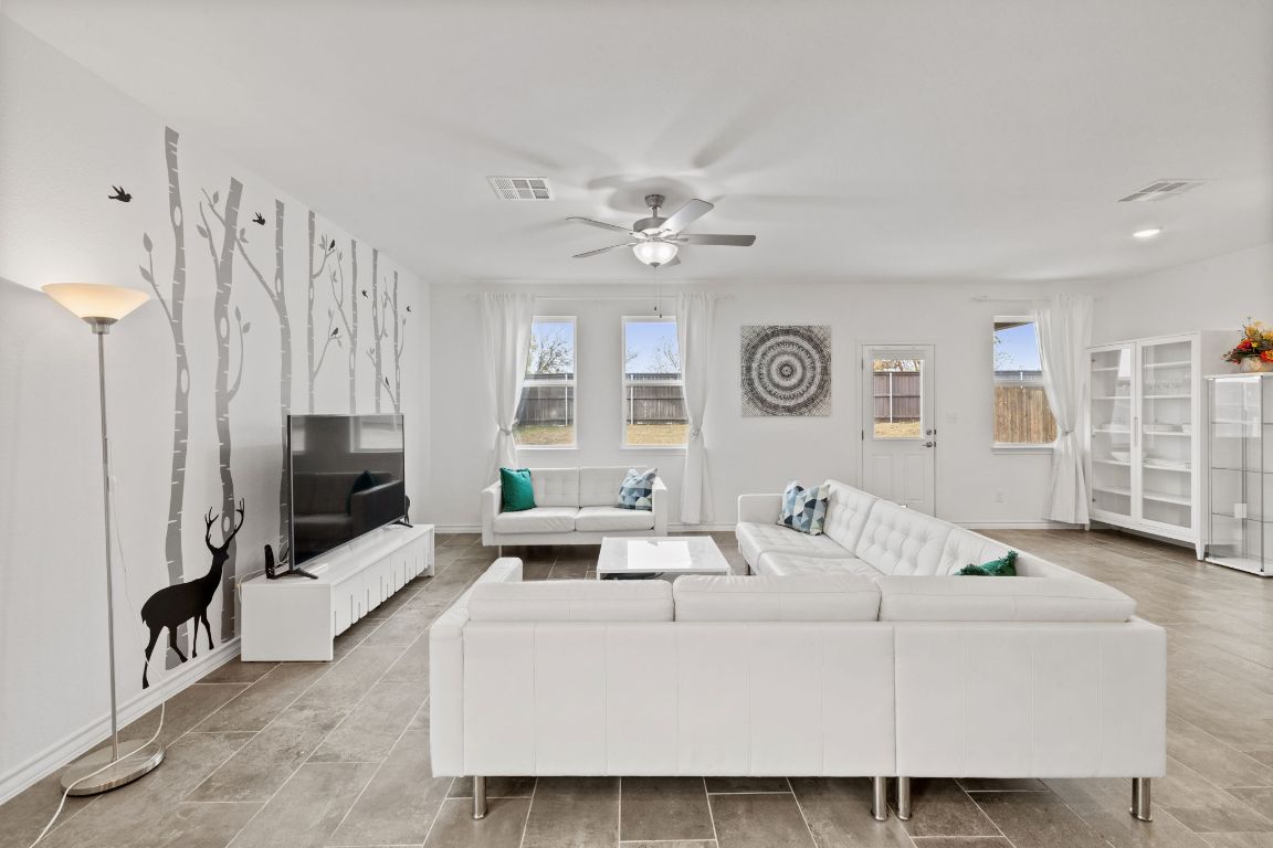 116 Thurman Holt Road Hutto, TX 78634 - Photo 16 of 35 Living area with healthy amount of natural light and ceiling fan