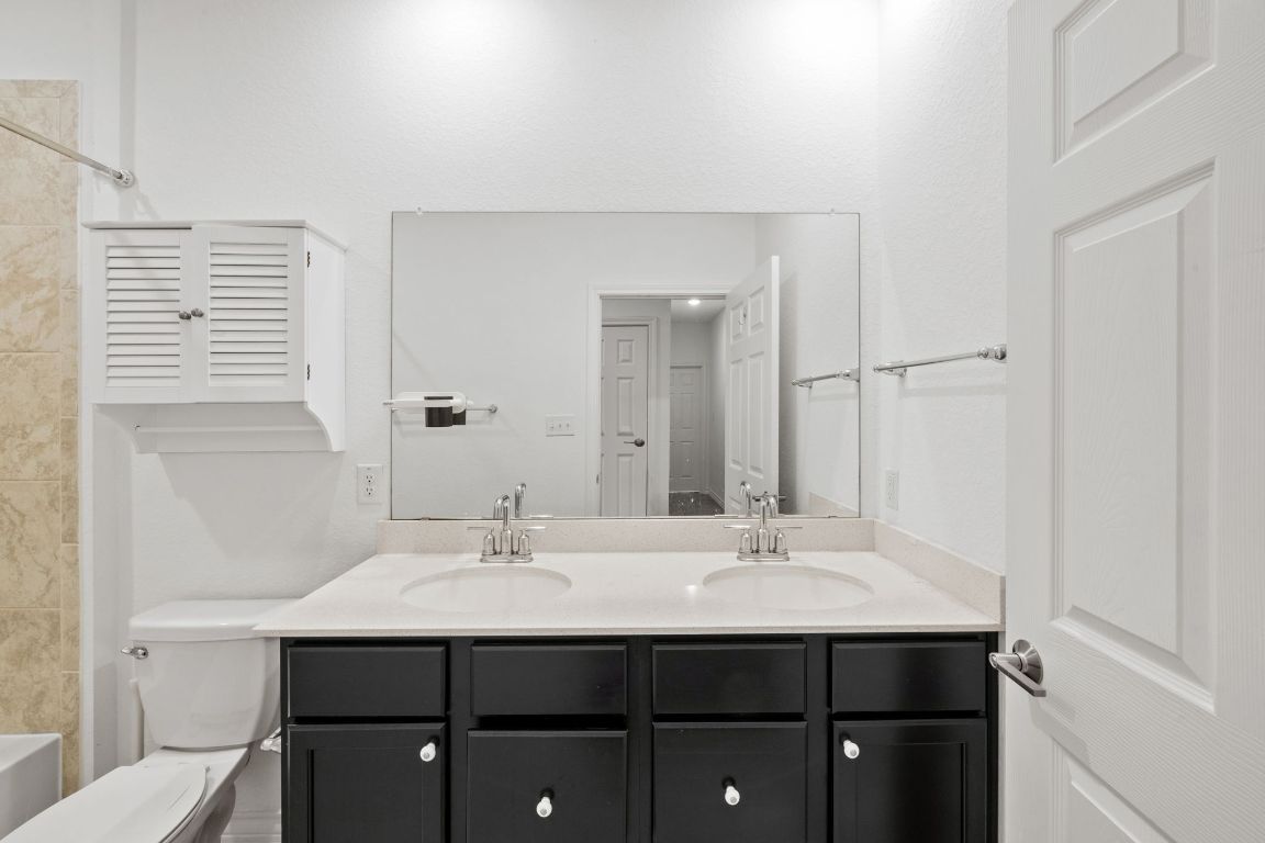 116 Thurman Holt Road Hutto, TX 78634 - Photo 23 of 35 Full bathroom with double vanity and shower combination