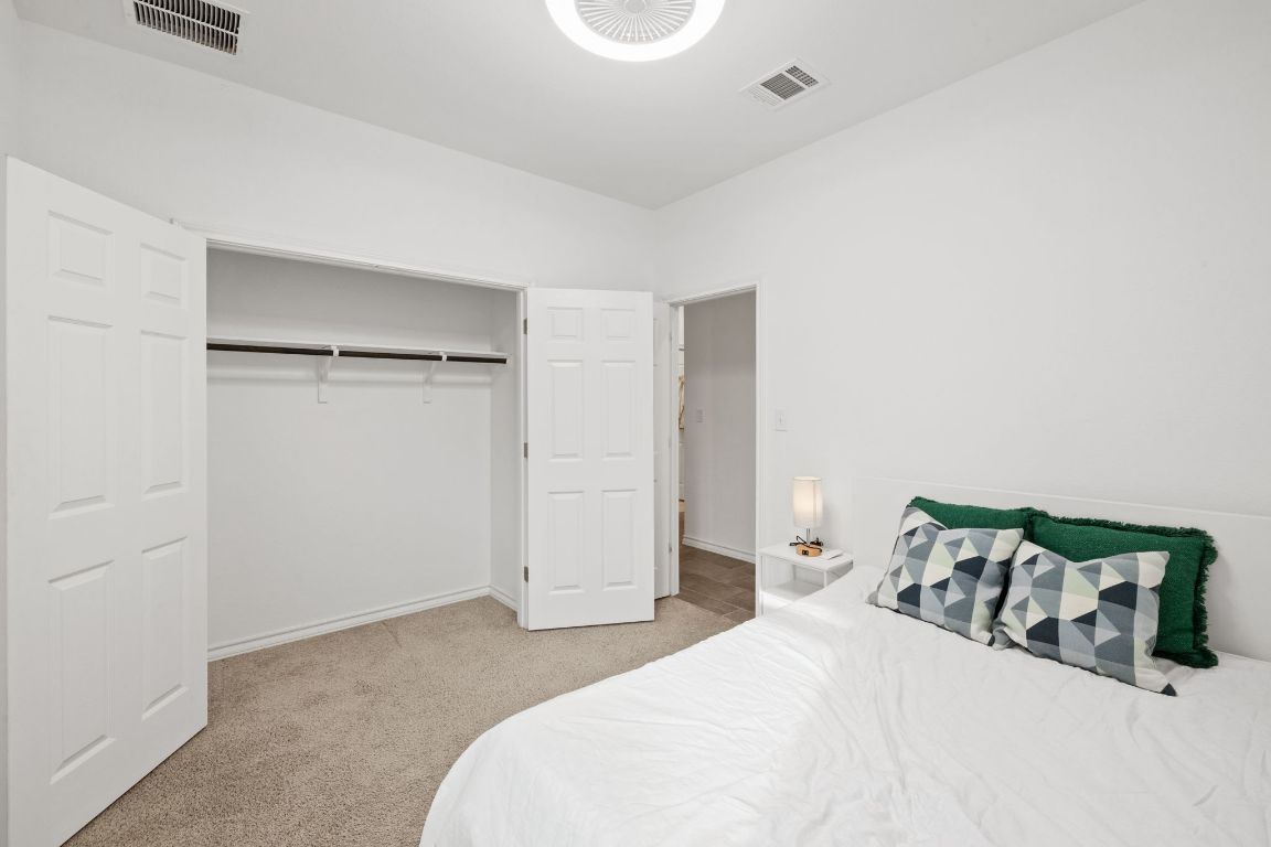 116 Thurman Holt Road Hutto, TX 78634 - Photo 25 of 35 Bedroom featuring light colored carpet and a closet