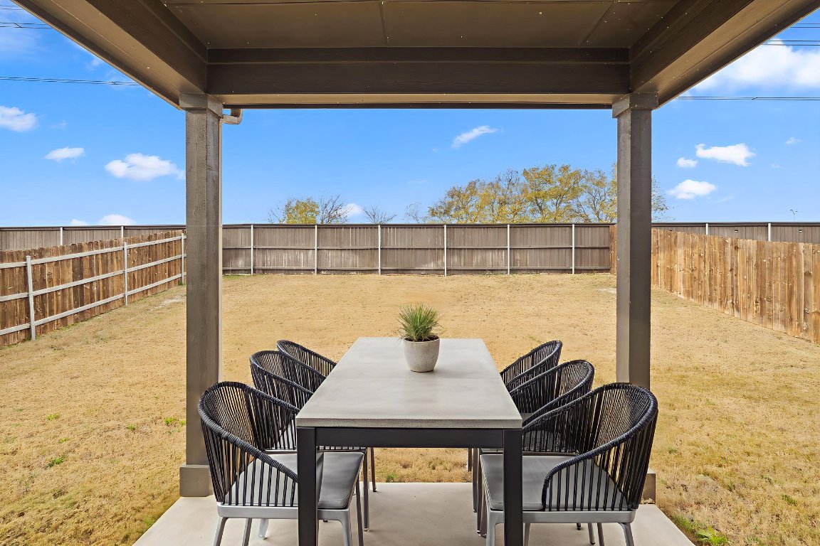 116 Thurman Holt Road Hutto, TX 78634 - Photo 30 of 35 Fenced backyard with a patio and outdoor dining space