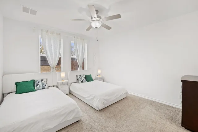 a bedroom with a bed and a large mirror