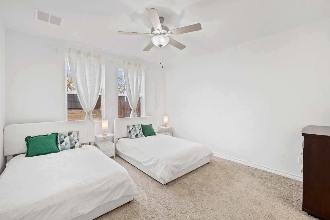 116 Thurman Holt Road Hutto, TX 78634 - Photo 8 of 35 Bedroom with carpet floors and a ceiling fan