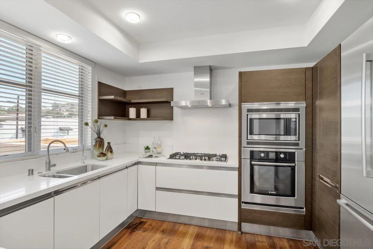 215 2nd Street, Unit 104 Encinitas, CA 92024 - Photo 13 of 22 a kitchen with a sink and stainless steel appliances