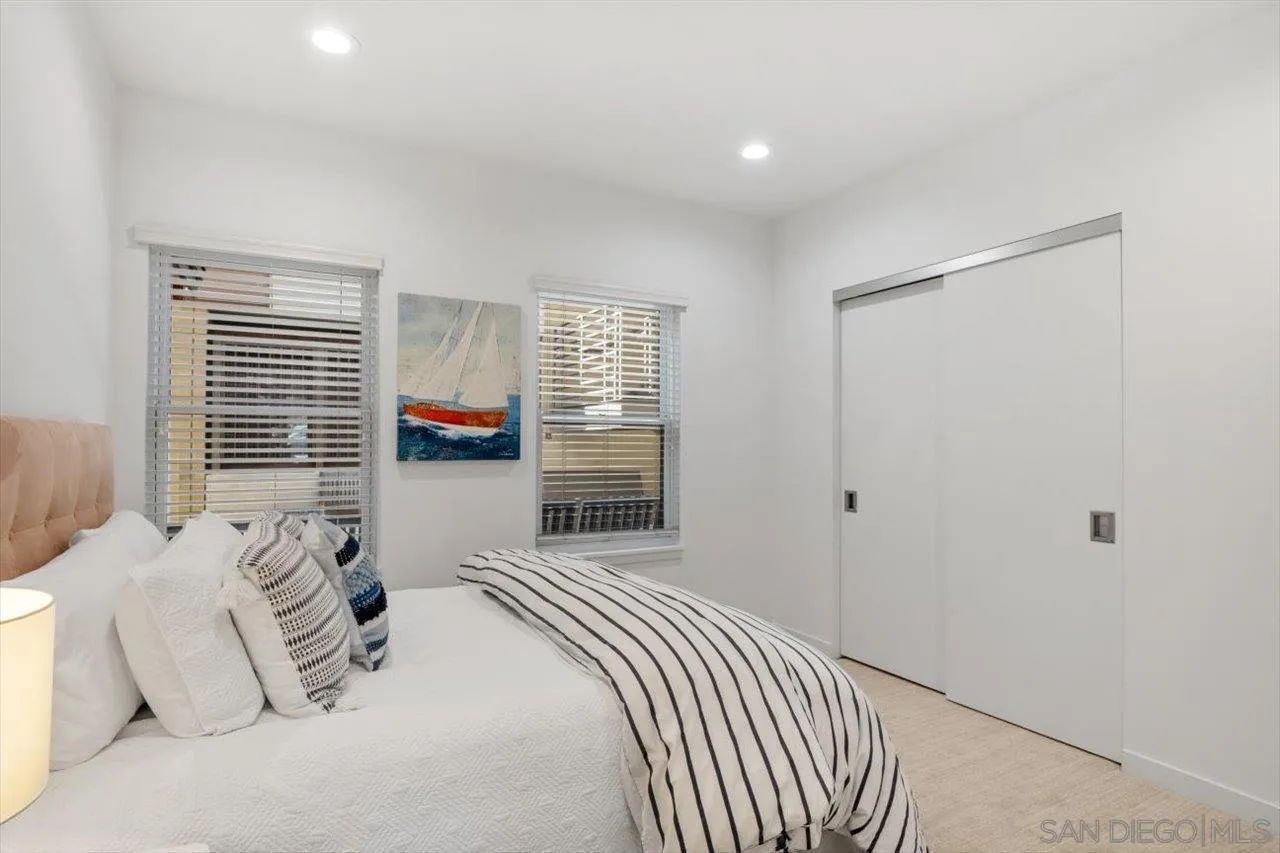 215 2nd Street, Unit 104 Encinitas, CA 92024 - Photo 5 of 22 a bedroom with a large bed and a window