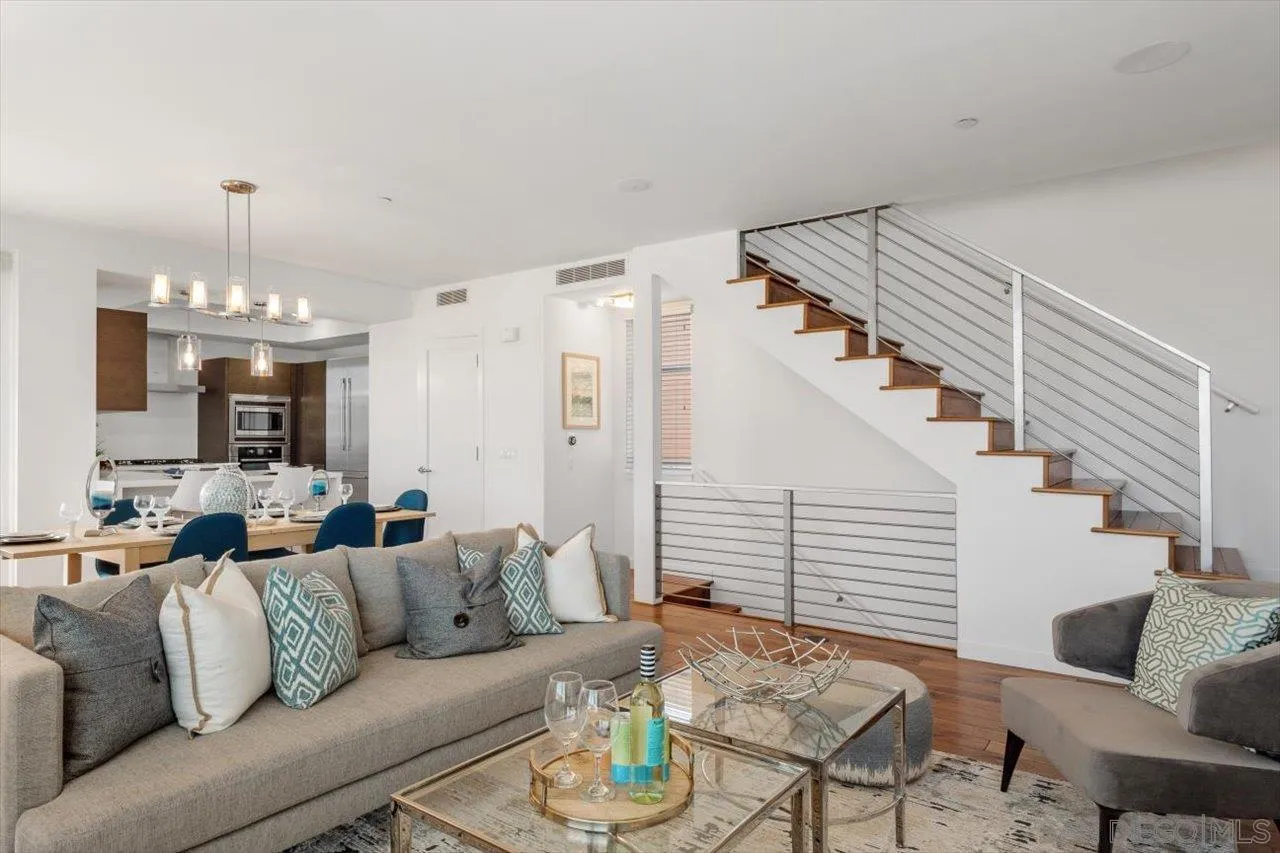 215 2nd Street, Unit 104 Encinitas, CA 92024 - Photo 9 of 22 a living room with furniture and a chandelier