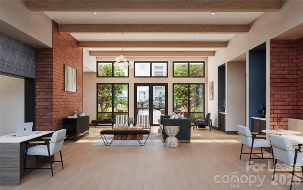 a living room with furniture and large windows