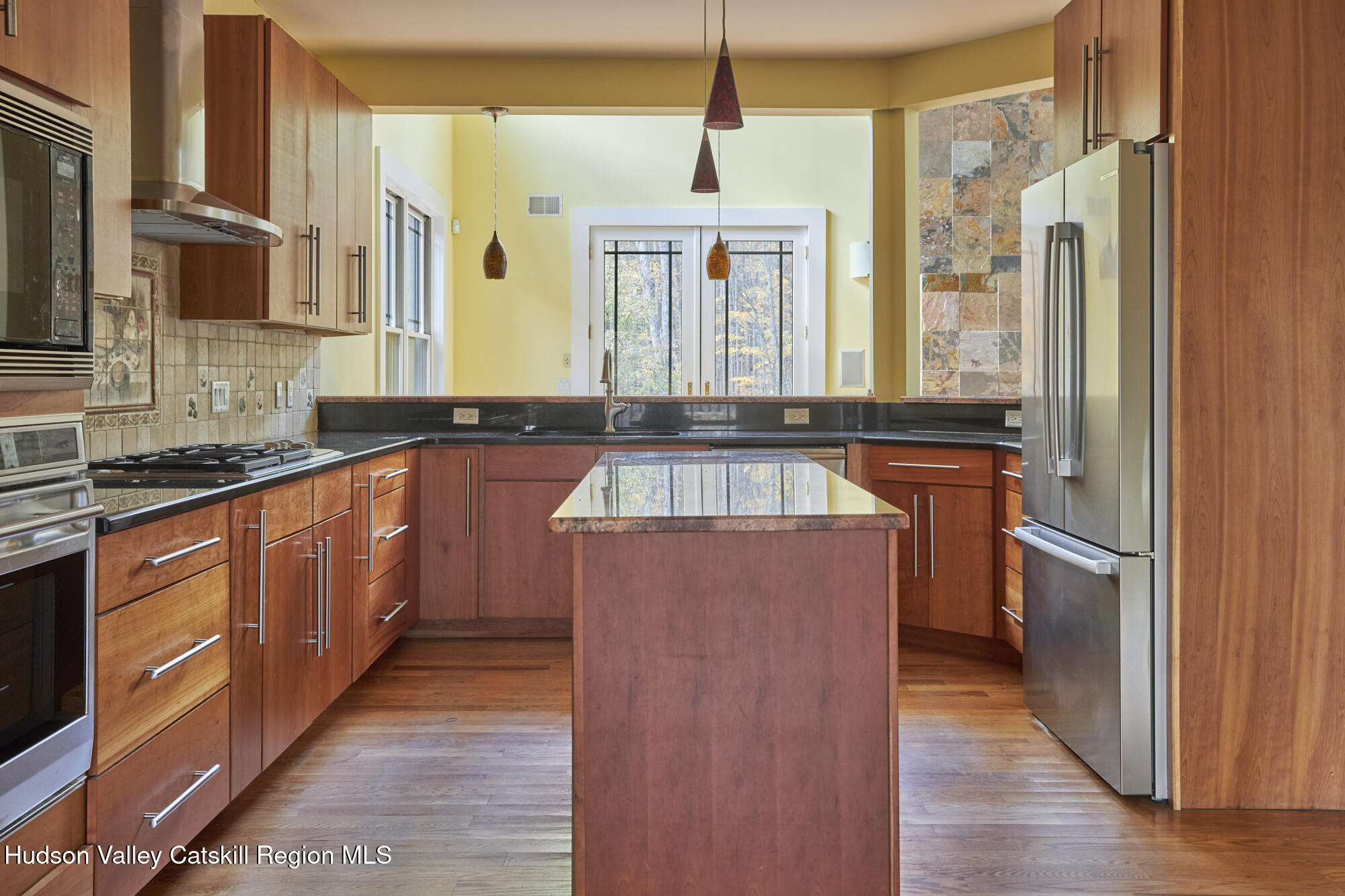 203 Silver Lake Road Rhinebeck, NY 12572 - Photo 12 of 46 a large kitchen with stainless steel appliances granite countertop a sink and wooden cabinets