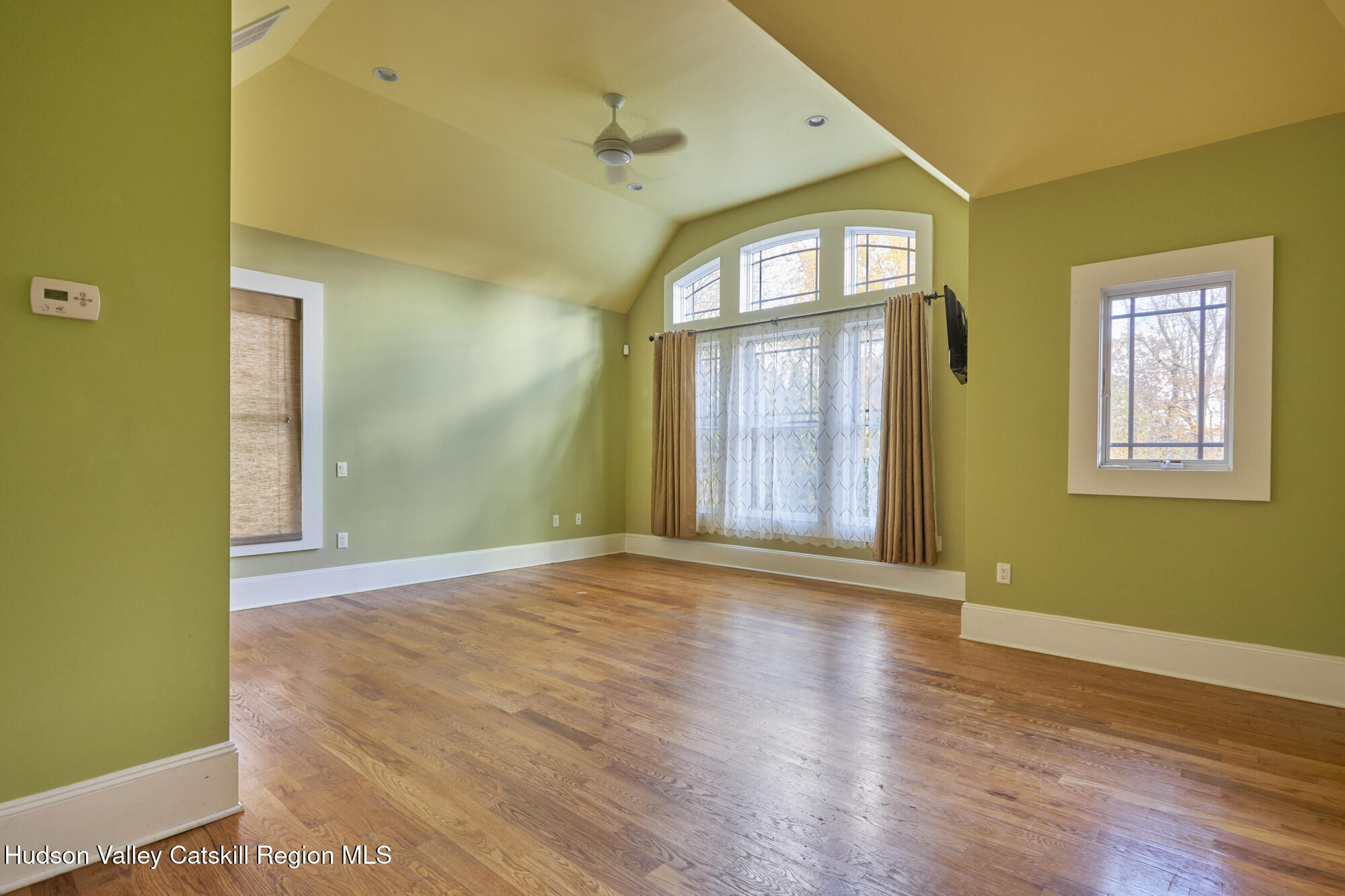 203 Silver Lake Road Rhinebeck, NY 12572 - Photo 20 of 46 an empty room with wooden floor and windows