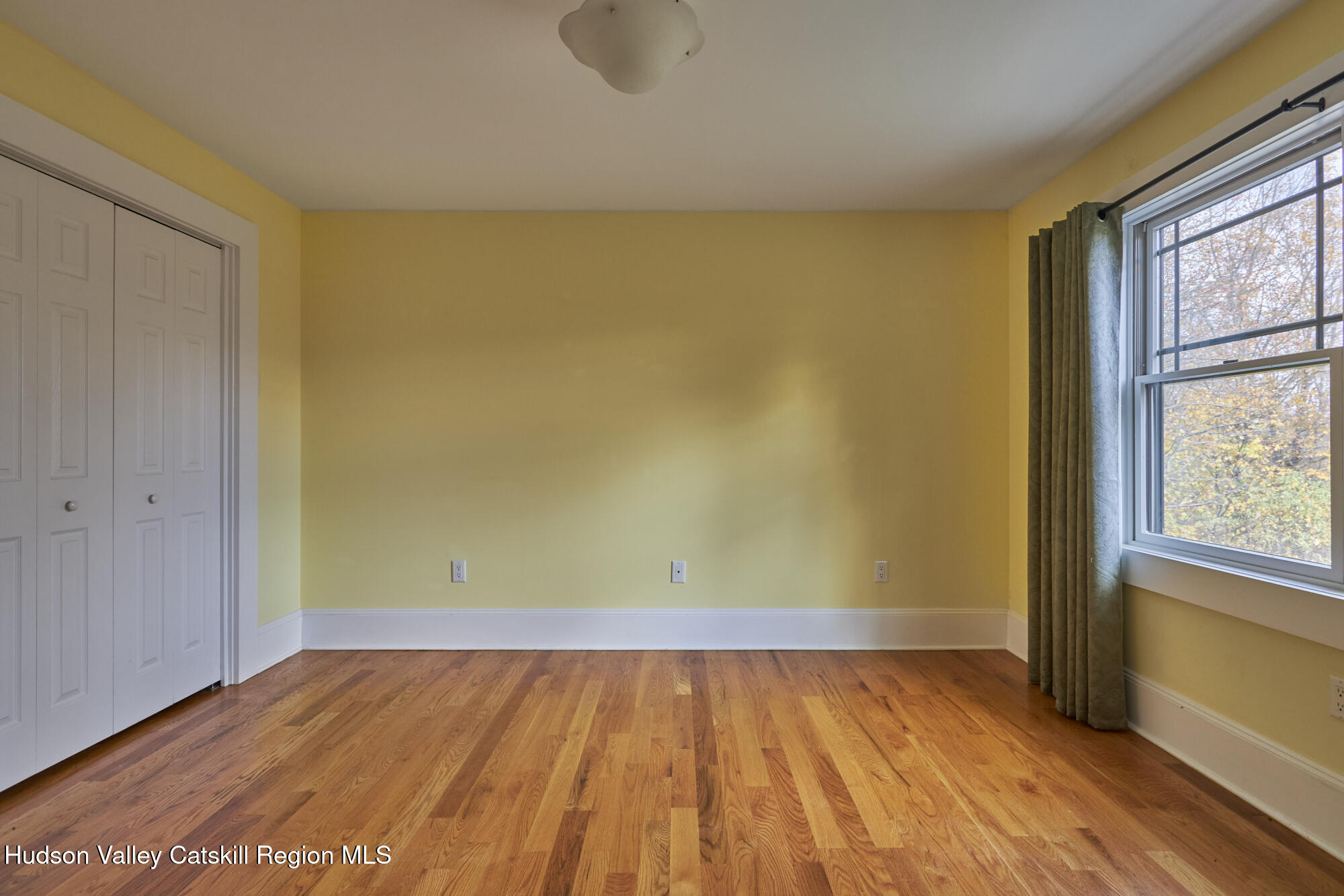 203 Silver Lake Road Rhinebeck, NY 12572 - Photo 26 of 46 a view of a room with wooden floor and brick walls