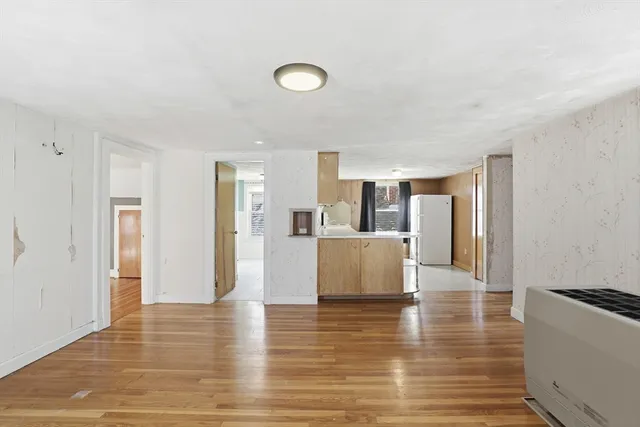a view of a kitchen with furniture and wooden floor