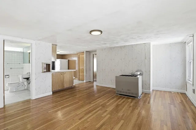 a view of a kitchen with furniture and wooden floor