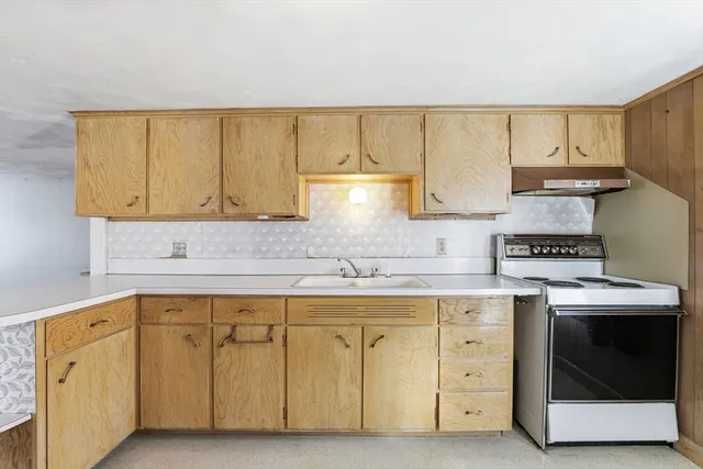 a kitchen with cabinets appliances and a sink