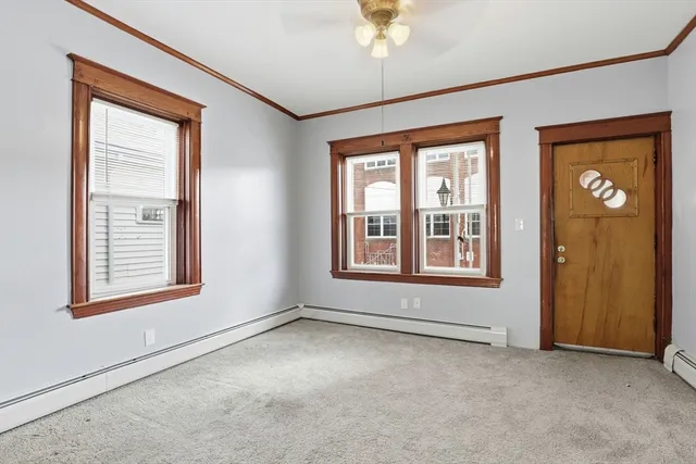 an empty room with windows and closet