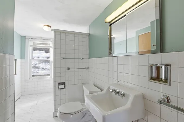 a bathroom with a toilet sink and shower