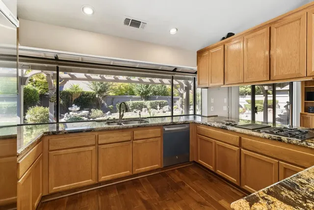 a kitchen with granite countertop cabinets and stainless steel appliances