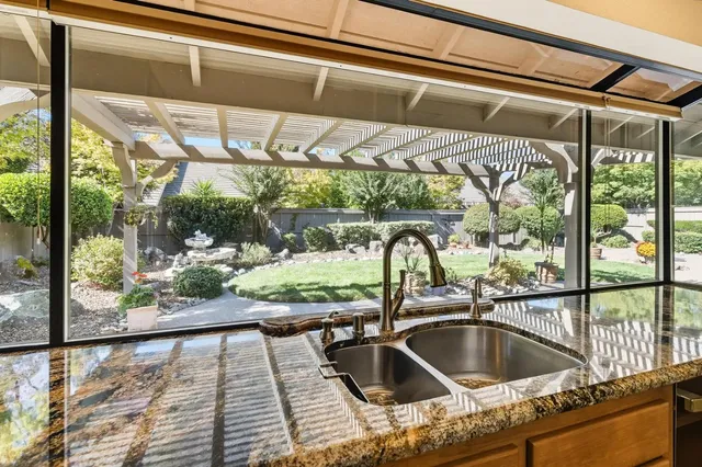 a view of empty room with floor to ceiling window and stairs