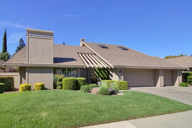 a front view of a house with a garden