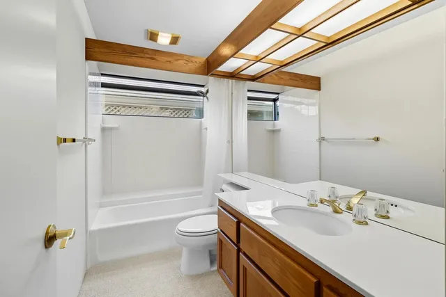 a view of an empty room with cabinet and a window