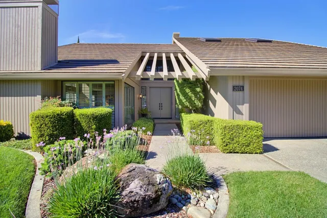 a front view of a house with a yard