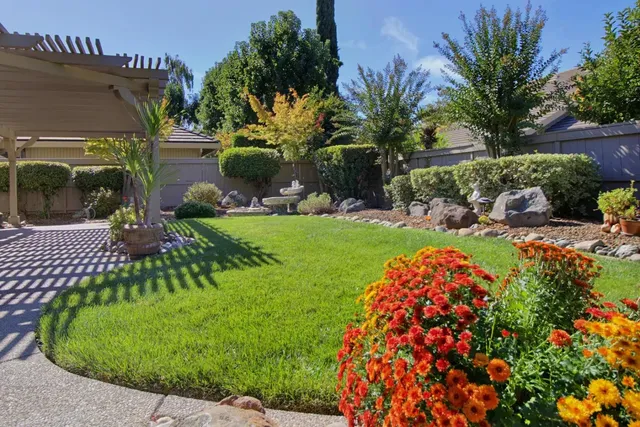 a front view of a house with a garden