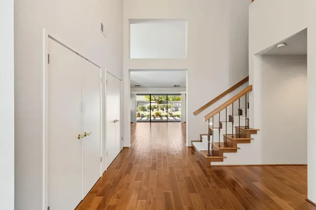 a view of staircase with wooden floor and a chandelier