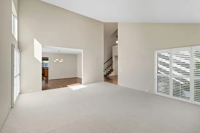 an empty room with furniture and windows