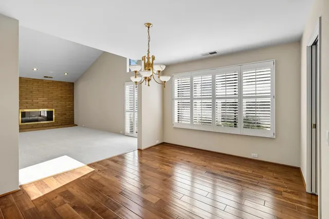 a view of a livingroom with wooden floor and a flat screen tv