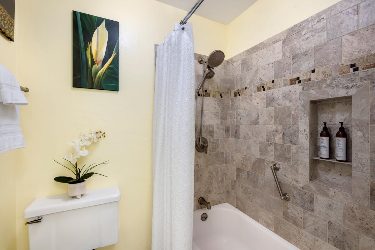 525 Aleka Loop, Unit E3 Kapaa, HI 96746 - Photo 15 of 23 a bathroom with a granite countertop sink a toilet and shower