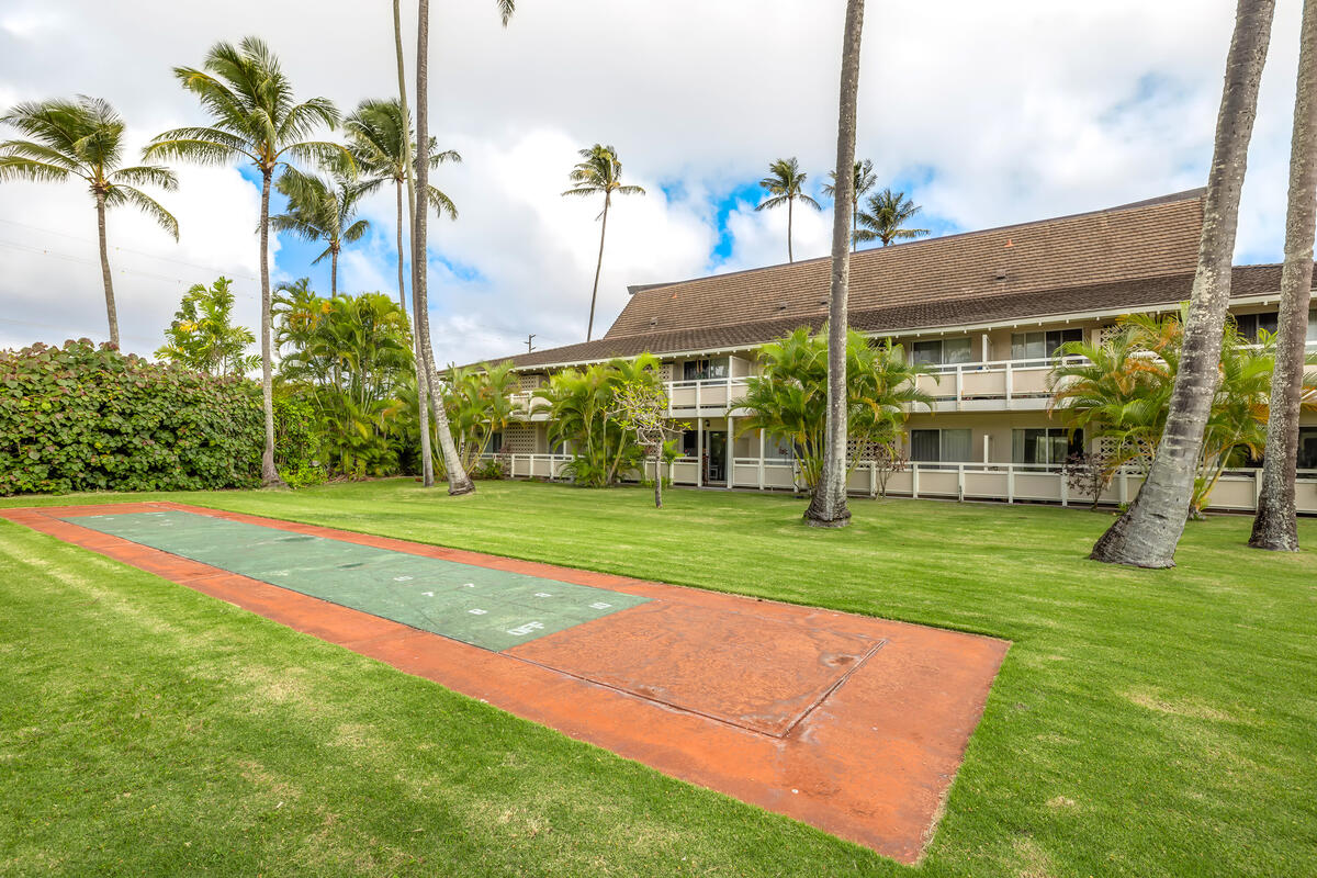 525 Aleka Loop, Unit E3 Kapaa, HI 96746 - Photo 17 of 23 a view of a house with a big yard and palm trees