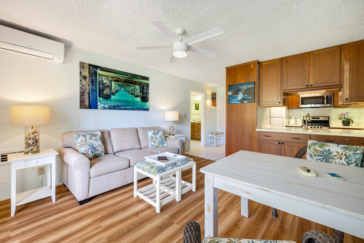 525 Aleka Loop, Unit E3 Kapaa, HI 96746 - Photo 7 of 23 a living room with furniture a flat screen tv and a table