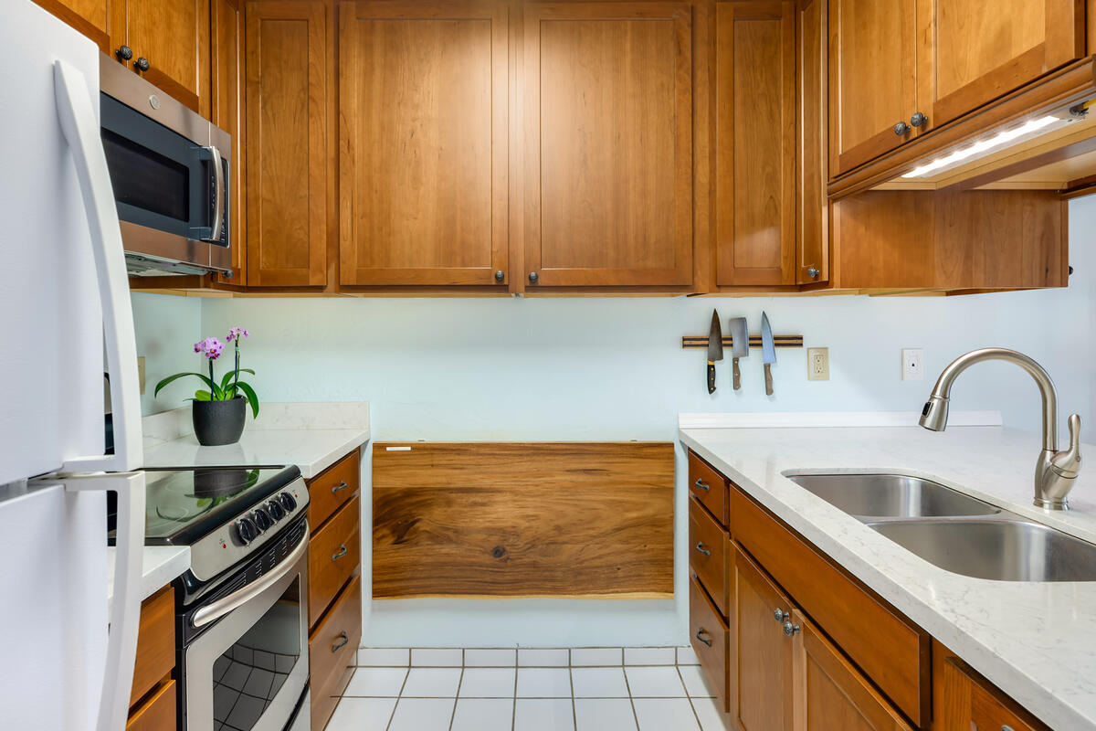 525 Aleka Loop, Unit E3 Kapaa, HI 96746 - Photo 10 of 23 a kitchen with stainless steel appliances granite countertop a sink stove and microwave