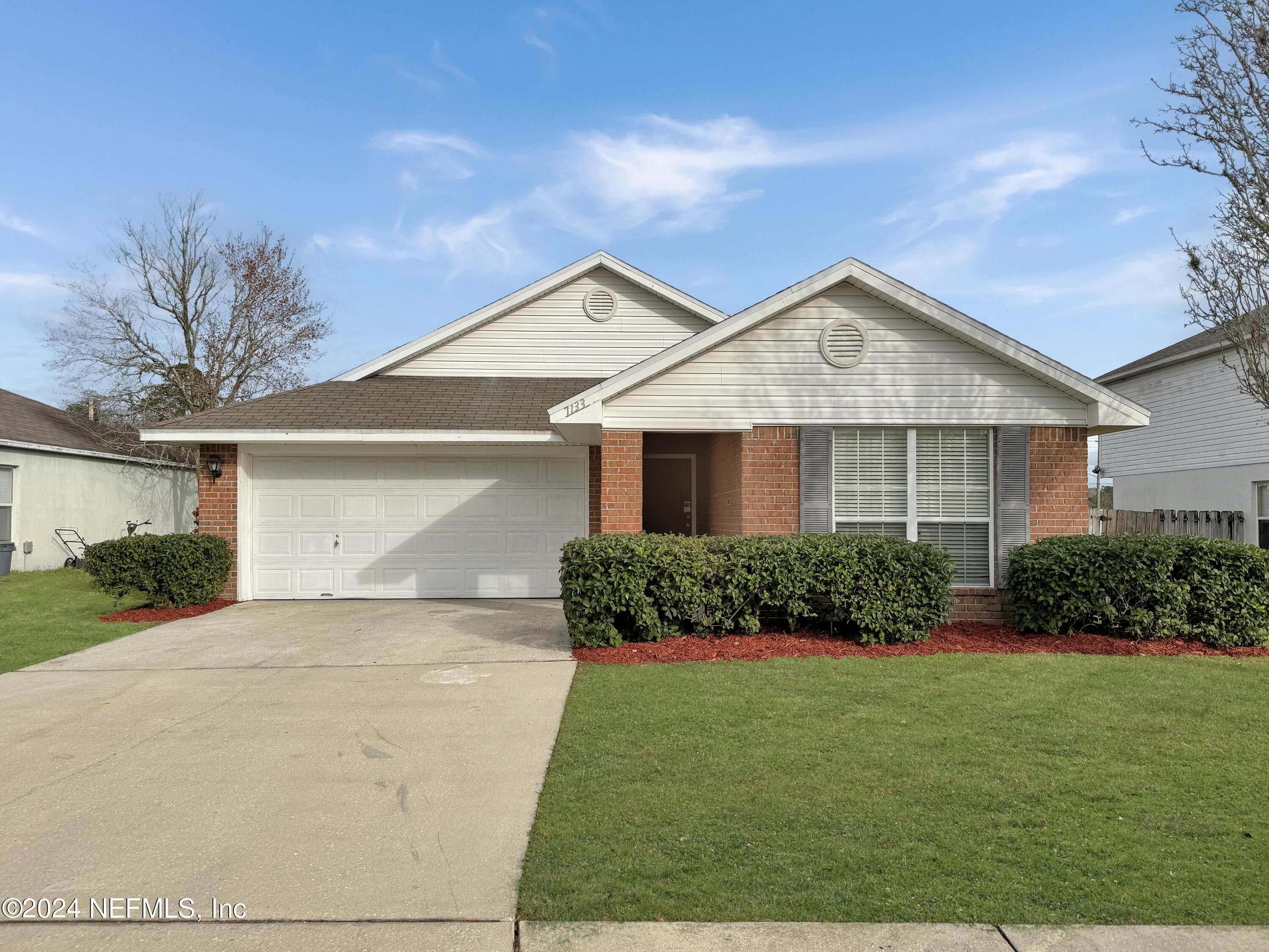 7133 High Bluff Road Jacksonville, FL 32244 - Photo 1 of 17 a front view of a house with a yard and garage