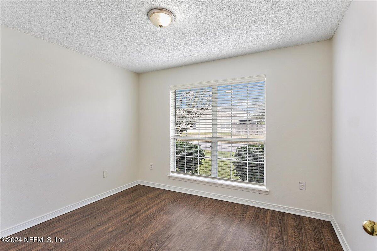 7133 High Bluff Road Jacksonville, FL 32244 - Photo 12 of 17 an empty room with wooden floor and windows