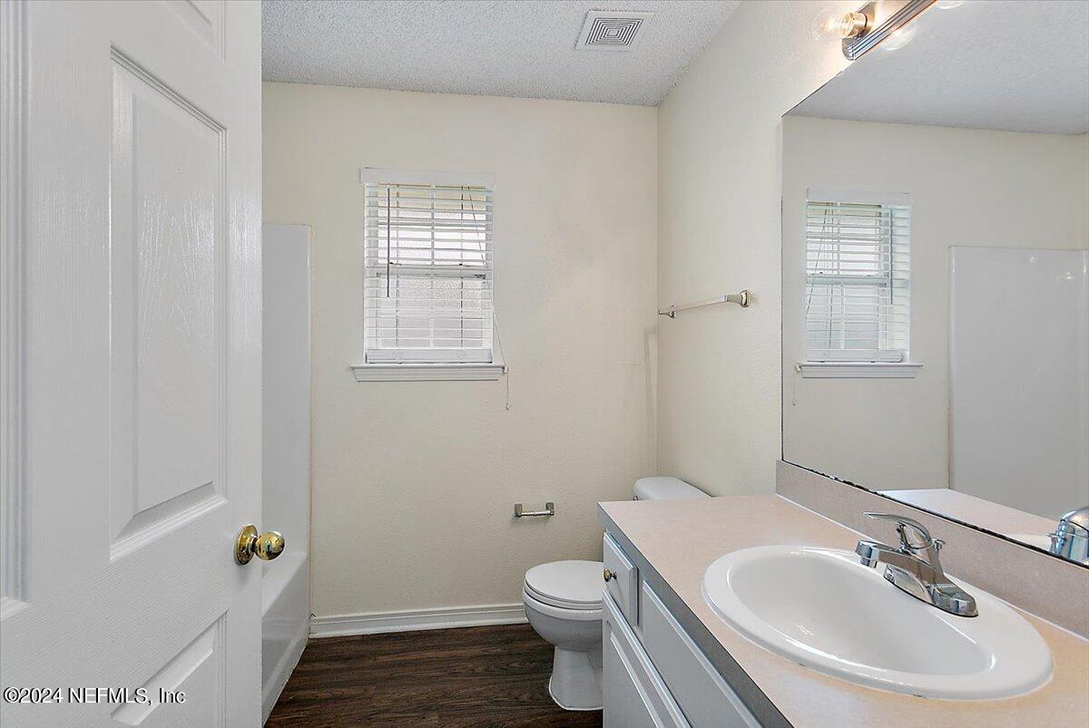 7133 High Bluff Road Jacksonville, FL 32244 - Photo 13 of 17 a bathroom with a sink a toilet and tub