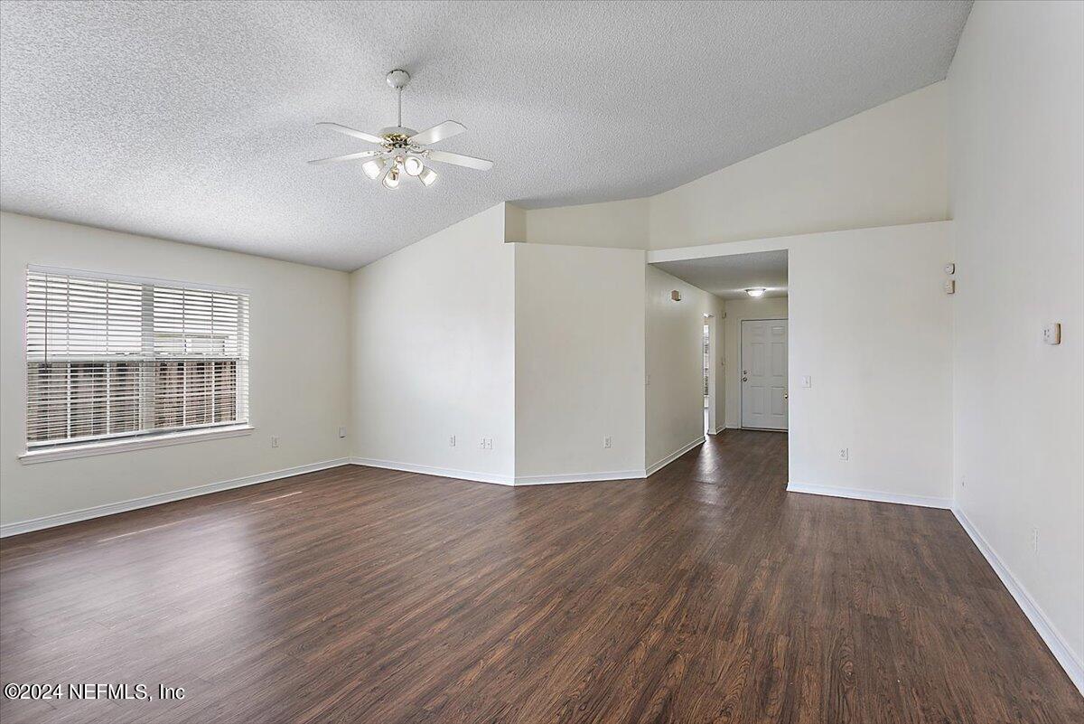 7133 High Bluff Road Jacksonville, FL 32244 - Photo 5 of 17 a view of an empty room with wooden floor and a window