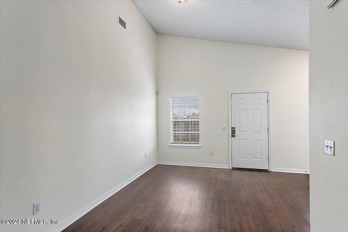 7133 High Bluff Road Jacksonville, FL 32244 - Photo 6 of 17 a view of a room with wooden floor and window