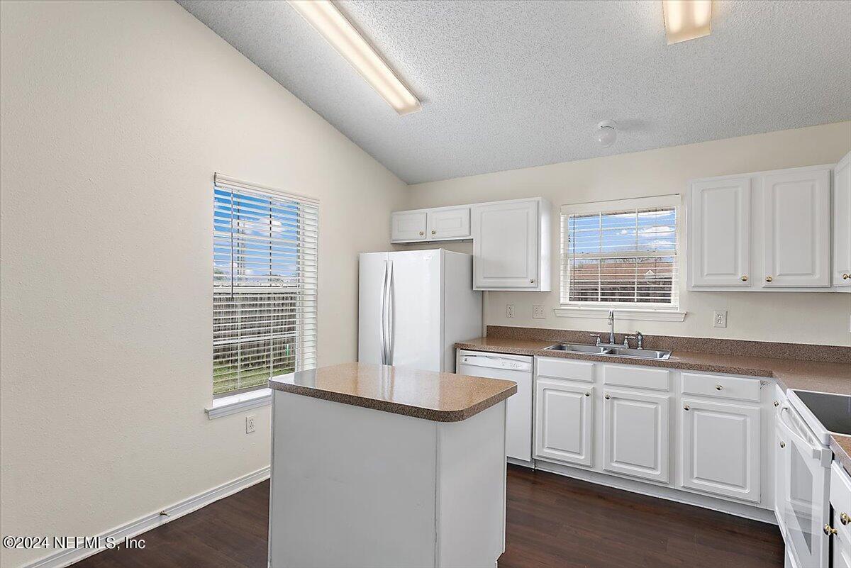 7133 High Bluff Road Jacksonville, FL 32244 - Photo 8 of 17 a kitchen with stainless steel appliances a sink stove and cabinets