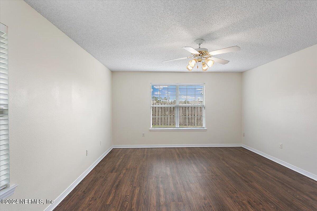 7133 High Bluff Road Jacksonville, FL 32244 - Photo 9 of 17 wooden floor in an empty room with a window