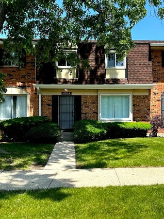 a view of a house with a yard and plants