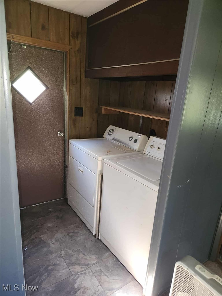 51036 Rochester Road Pleasant City, OH 43772 - Photo 7 of 22 Laundry area with washing machine and dryer and wood walls