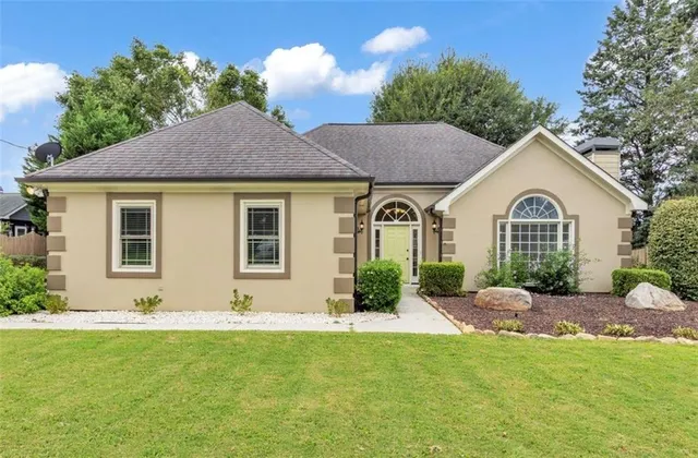 a front view of a house with garden