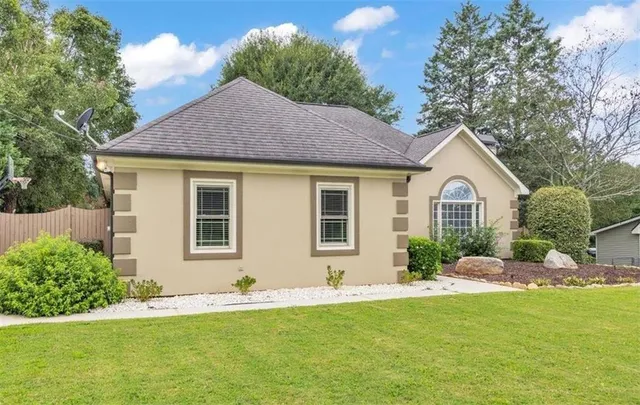 a front view of house with yard and green space