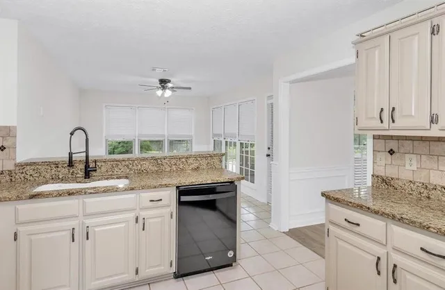 a kitchen with stainless steel appliances granite countertop a sink and cabinets