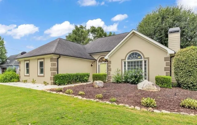 a front view of a house with garden