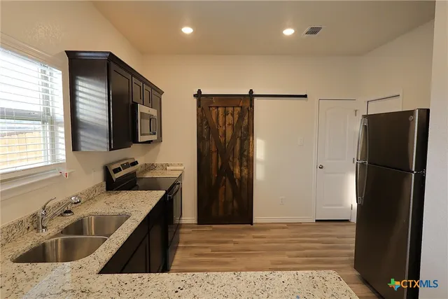 a kitchen with a sink a refrigerator and a sink