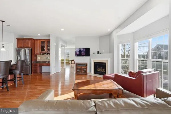 a living room with furniture large window and a fireplace